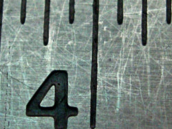 Close-up of a ruler showing the number four.